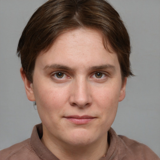 Joyful white young-adult female with short  brown hair and grey eyes