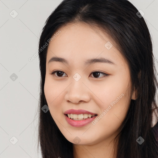 Joyful asian young-adult female with long  black hair and brown eyes