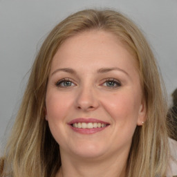 Joyful white young-adult female with long  brown hair and grey eyes