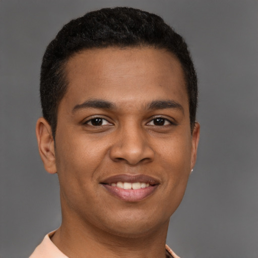 Joyful latino young-adult male with short  brown hair and brown eyes