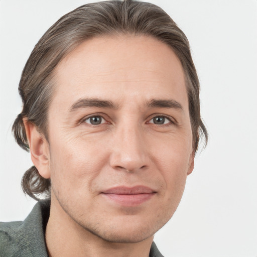 Joyful white adult male with short  brown hair and grey eyes