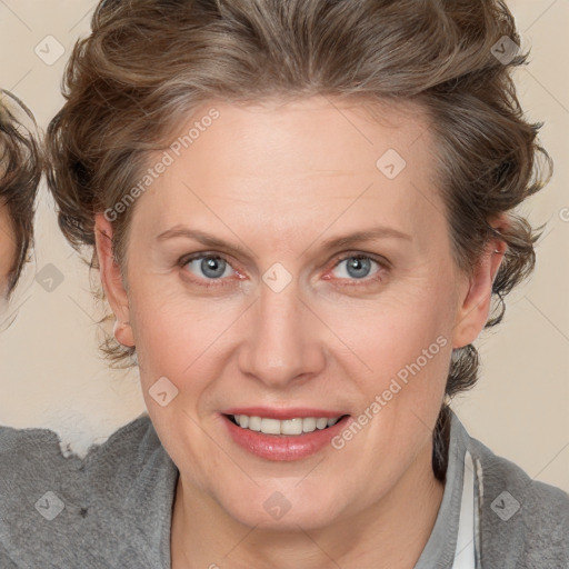 Joyful white adult female with medium  brown hair and blue eyes