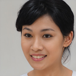 Joyful asian young-adult female with medium  black hair and brown eyes