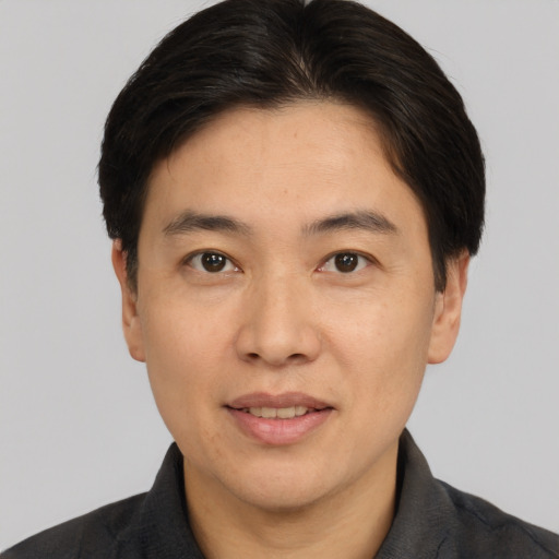 Joyful white adult male with short  brown hair and brown eyes
