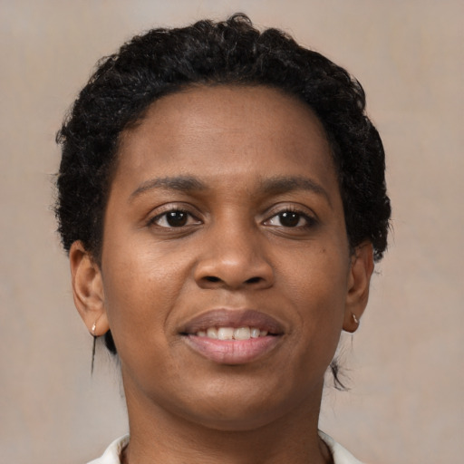 Joyful black young-adult female with short  brown hair and brown eyes