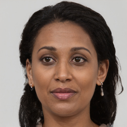 Joyful black adult female with medium  black hair and brown eyes