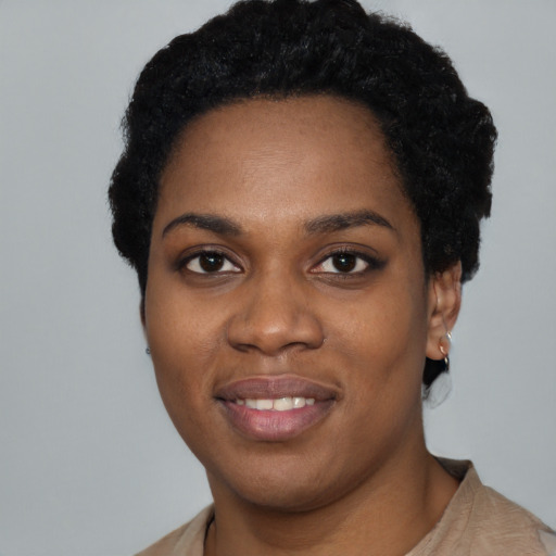 Joyful black young-adult female with short  black hair and brown eyes