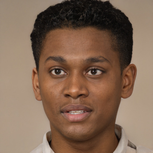 Joyful black young-adult male with short  brown hair and brown eyes