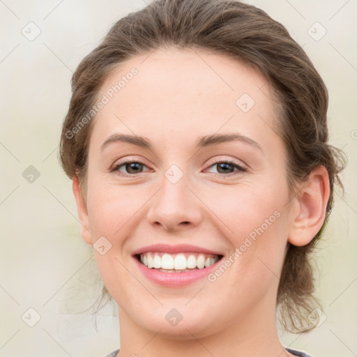 Joyful white young-adult female with medium  brown hair and green eyes