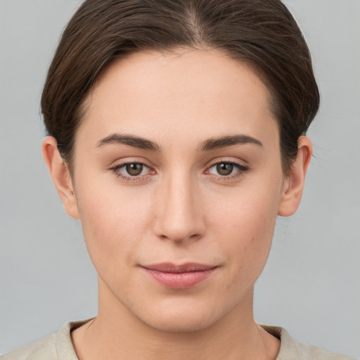 Joyful white young-adult female with short  brown hair and grey eyes