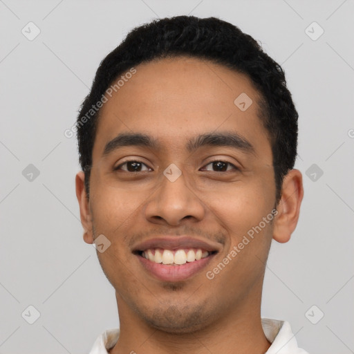 Joyful latino young-adult male with short  black hair and brown eyes