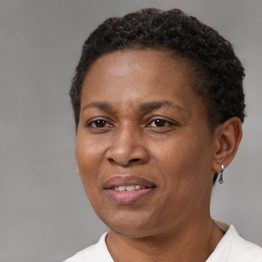 Joyful black adult female with short  brown hair and brown eyes