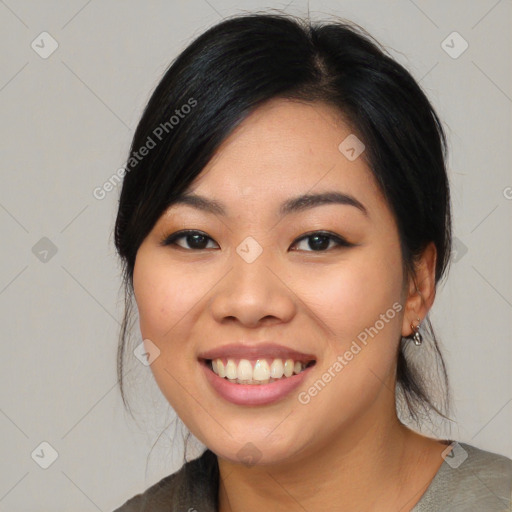 Joyful asian young-adult female with medium  black hair and brown eyes