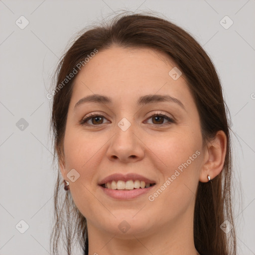 Joyful white young-adult female with long  brown hair and grey eyes