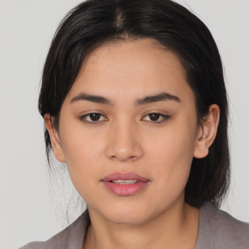 Joyful white young-adult female with medium  black hair and brown eyes