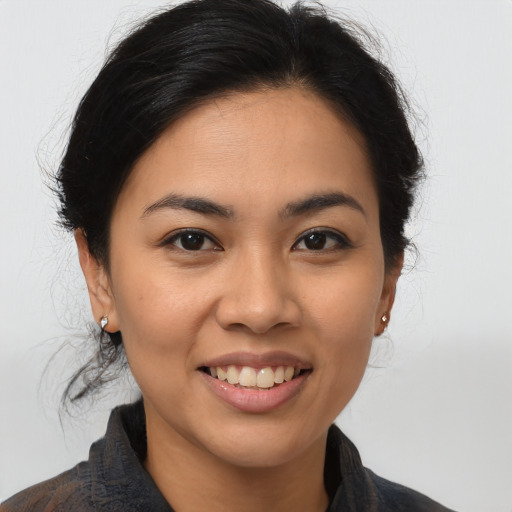 Joyful asian young-adult female with medium  brown hair and brown eyes