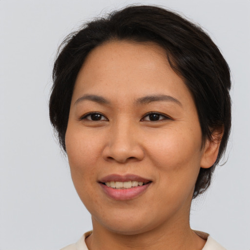 Joyful asian young-adult female with medium  brown hair and brown eyes