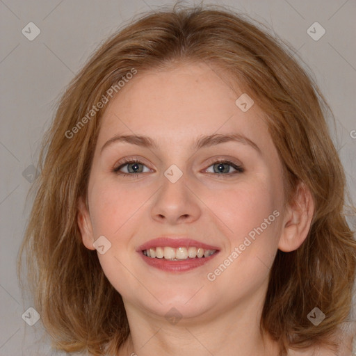 Joyful white young-adult female with long  brown hair and blue eyes