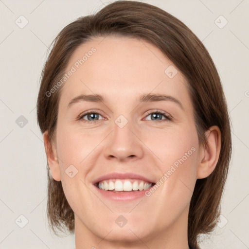 Joyful white young-adult female with medium  brown hair and green eyes