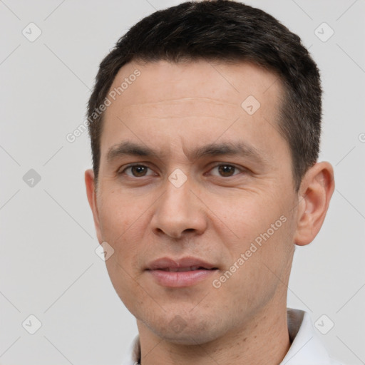 Joyful white young-adult male with short  black hair and brown eyes