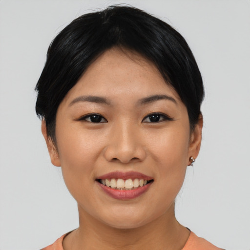 Joyful asian young-adult female with short  black hair and brown eyes