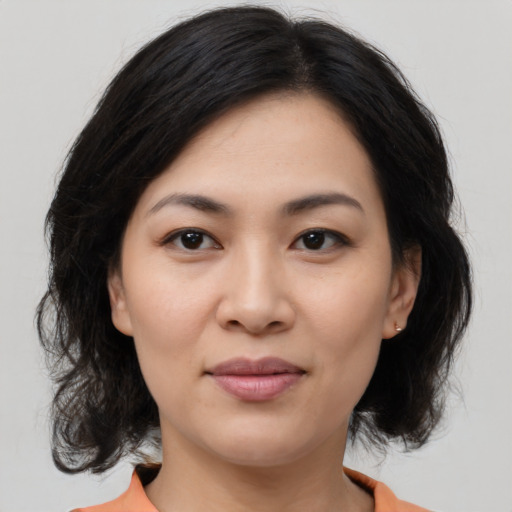 Joyful asian young-adult female with medium  brown hair and brown eyes