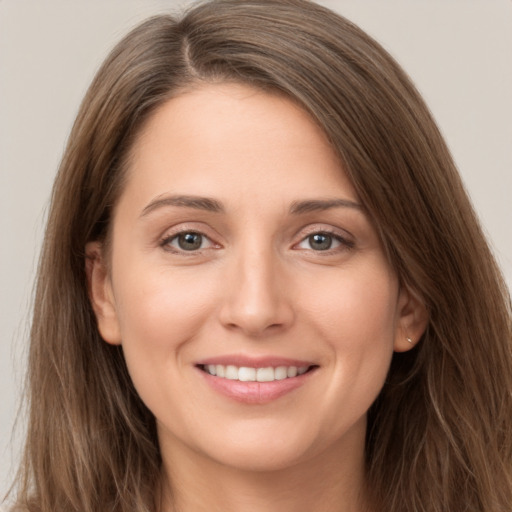 Joyful white young-adult female with long  brown hair and brown eyes