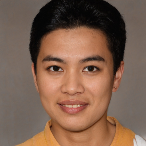 Joyful latino young-adult male with short  brown hair and brown eyes