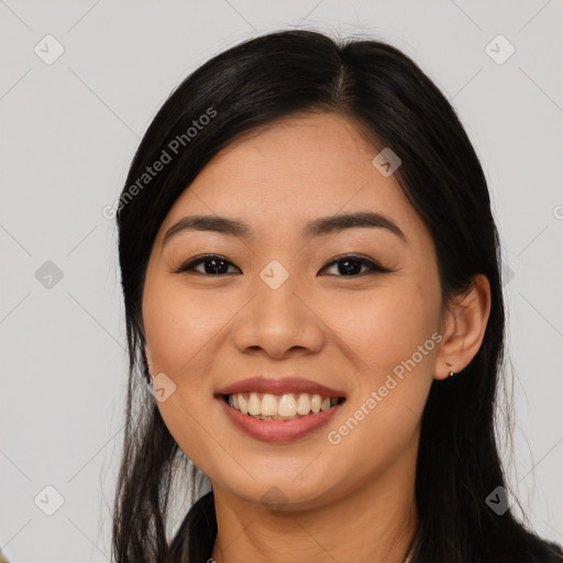 Joyful asian young-adult female with long  black hair and brown eyes