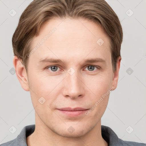 Joyful white young-adult male with short  brown hair and grey eyes