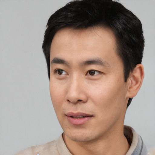 Neutral asian young-adult male with short  black hair and brown eyes
