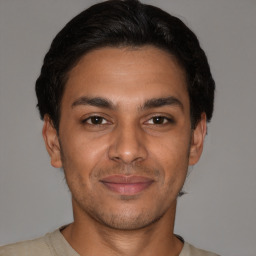 Joyful latino young-adult male with short  brown hair and brown eyes