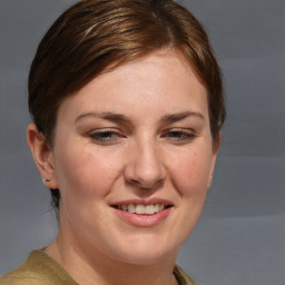 Joyful white adult female with medium  brown hair and blue eyes