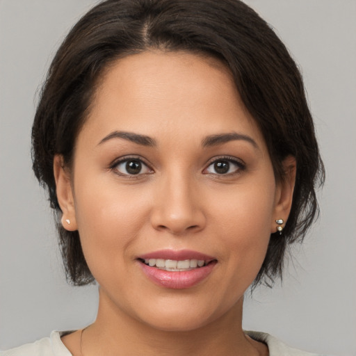 Joyful white young-adult female with medium  brown hair and brown eyes