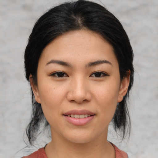 Joyful asian young-adult female with medium  black hair and brown eyes