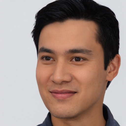 Joyful asian young-adult male with short  black hair and brown eyes