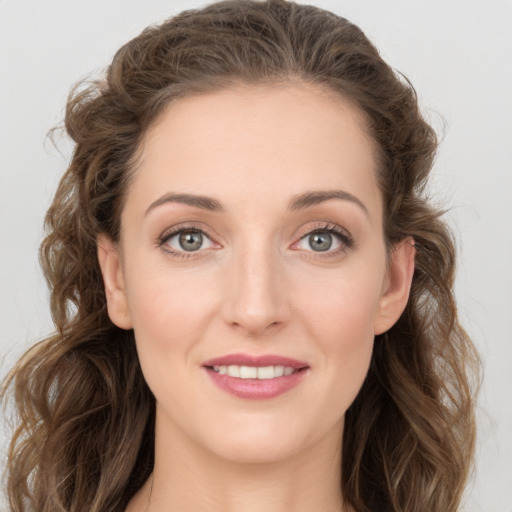 Joyful white young-adult female with long  brown hair and green eyes