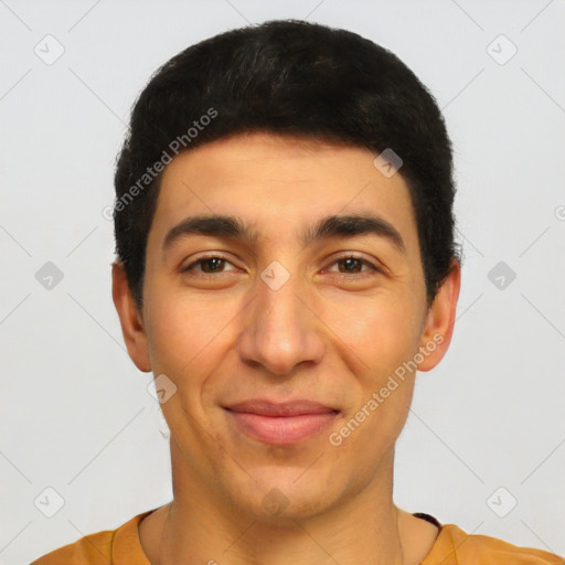 Joyful latino young-adult male with short  black hair and brown eyes