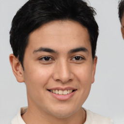 Joyful latino young-adult male with short  brown hair and brown eyes