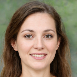 Joyful white young-adult female with long  brown hair and green eyes