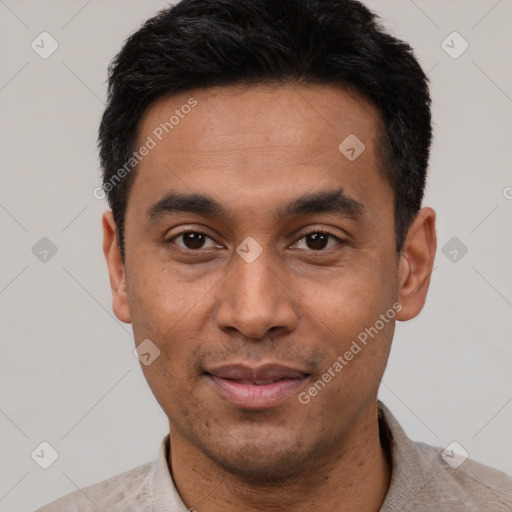 Joyful latino young-adult male with short  black hair and brown eyes