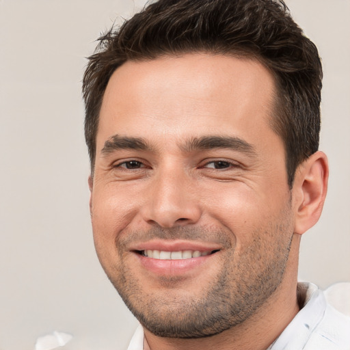 Joyful white young-adult male with short  brown hair and brown eyes