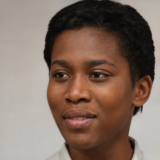 Joyful black young-adult female with short  black hair and brown eyes