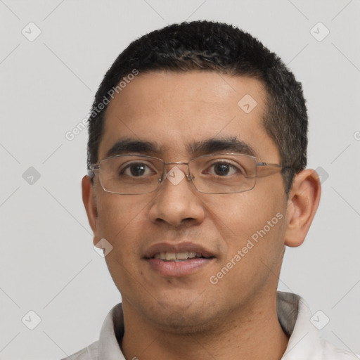 Joyful latino young-adult male with short  black hair and brown eyes