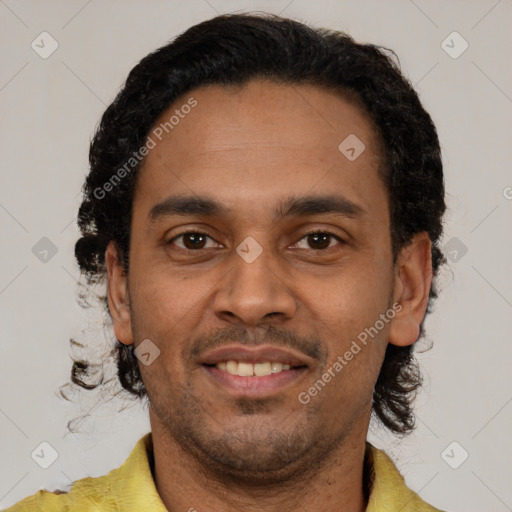 Joyful latino young-adult male with short  brown hair and brown eyes