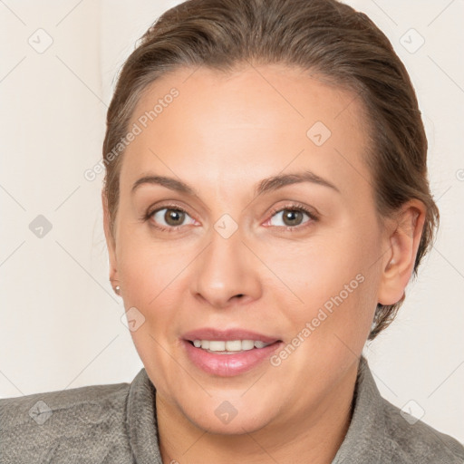 Joyful white adult female with medium  brown hair and brown eyes