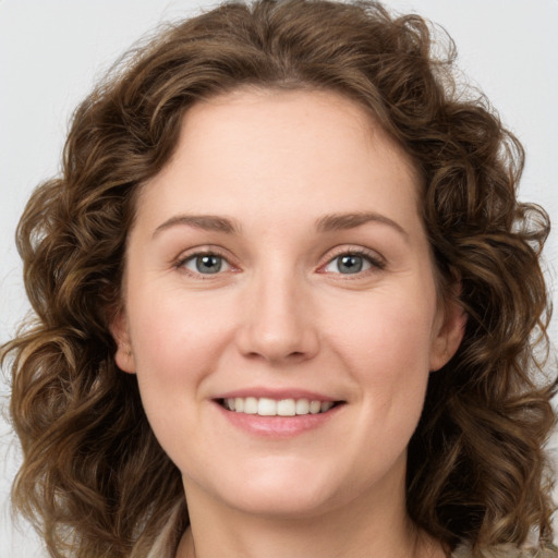 Joyful white young-adult female with long  brown hair and green eyes