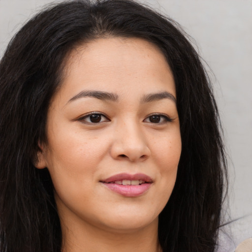 Joyful asian young-adult female with long  brown hair and brown eyes