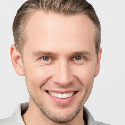 Joyful white adult male with short  brown hair and grey eyes