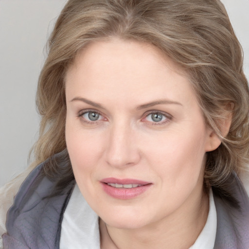 Joyful white young-adult female with medium  brown hair and blue eyes